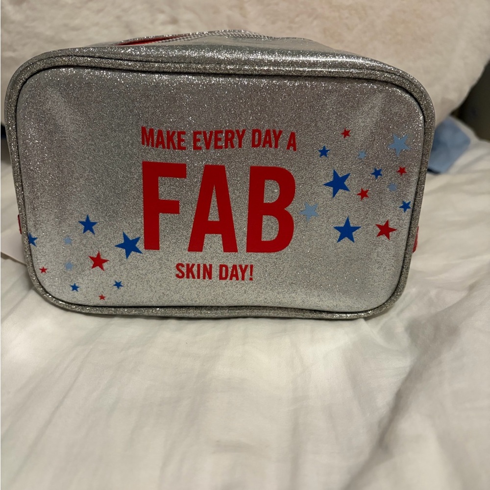 First Aid Beauty Silver and Red Bag